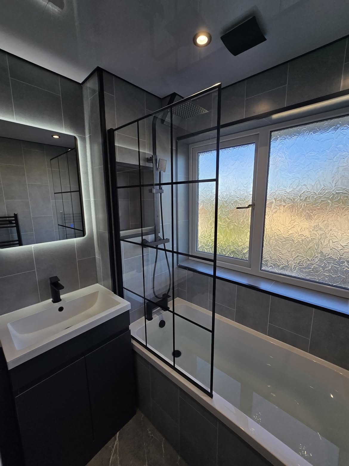 Black-framed bath screen with backlit mirror